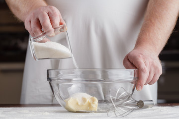 man the cook is occupied with dough preparation