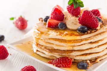 Pancakes with berries and maple syrup