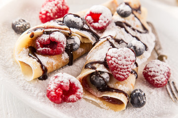 Pancakes with berries and maple syrup