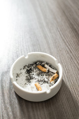 Ashtray with cigarette butts. Extinguished cigarettes.