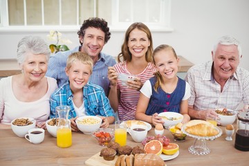 Multi-generation family having breakfast at home