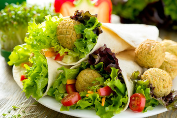 Tortilla wrap with falafel and fresh salad, vegetarian healthy food