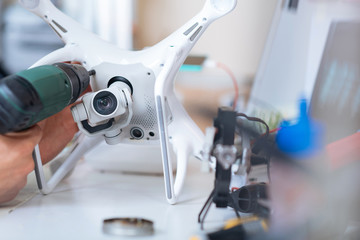 Close up of mans hands drilling drone landing gears.