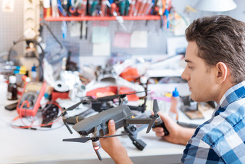 Young man holding drone propeller and remore controller