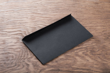 black envelope on  wooden table