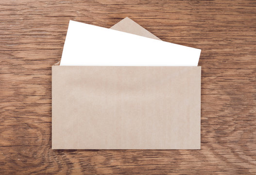 envelope whit blank on  wooden table