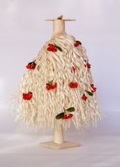 Christmas tree made of wood shavings with red berries 