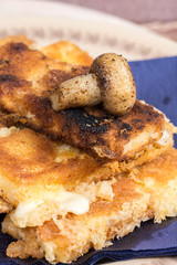 Fried mushroom with fried yellow cheese on eggs