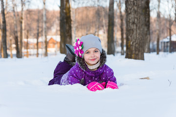 Fototapeta na wymiar girl lying in the snow