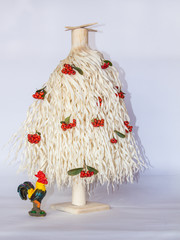 White wood shavings Christmas tree with red berries and a rooster 