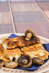Fried mushroom with fried yellow cheese on eggs