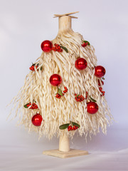 White wood shavings Christmas tree with red berries and red ornament