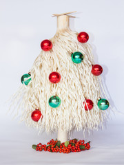 white Christmas tree made of wood shavings with red and green ball ornaments 