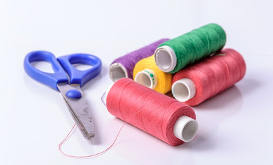 Colorful bobbin thread on white background