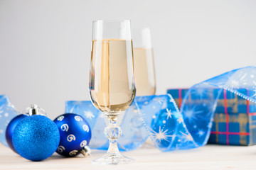 Glasses of champagne with gift box and christmas balls 