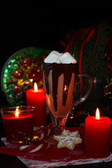 Christmas hot chocolade with marshmallow and homemade cookies decorated candles. Selective focus
