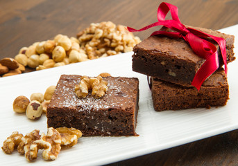 Cake chocolate brownies on white dish with nut