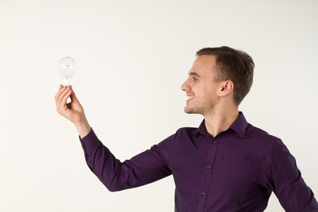A man with a light bulb. he has an idea. Office employee.