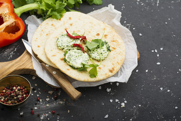 Green homemade butter from organic farming products based on seasonal herbs, parsley, cilantro, rosemary, thyme and pepper  sea salt. Served with tortillas  fresh bread for a snack. Selective focus