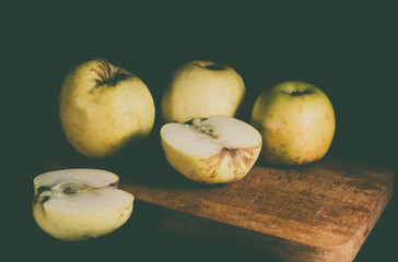 Yellow fresh apples on cutting Board