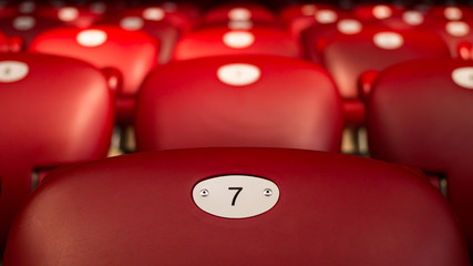 Lucky Number Seven On Empty Red Chair - 128512418