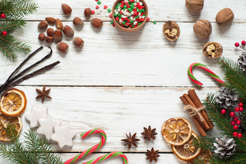 Spicy Christmas background. Anise cinnamon nuts fir tree baking ingredients.