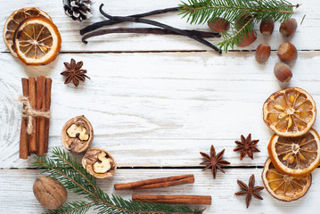 Spicy Christmas background. Anise cinnamon nuts fir tree baking ingredients.