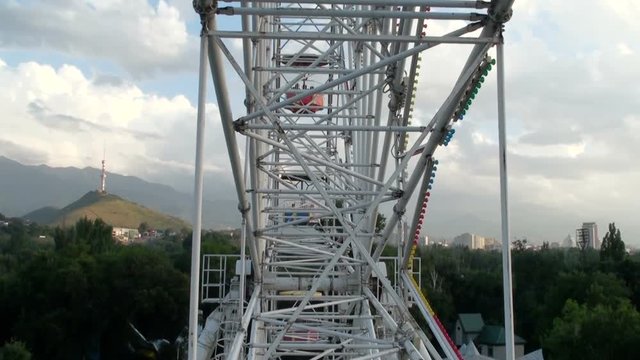 Ferris wheel in Gorky Park in Almaty Kazakhstan with scenic view on Kok Tobe Tower and Tian Shan mountains