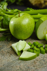 Green vegetables and fruits -  celery shoots and  apples, dietary fitness concept