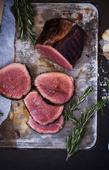 Beef tenderloin steak. Four pieces of beef fillet mignon on a metal tray with rosemary. Beef...