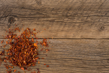 Dried red pepper on old wooden table.