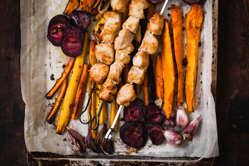 Grilled chicken and vegetable skewers with roasted vegetables. Chicken breast meat and vegetables. Dinner table with Grilled meat skewers and vegetables.