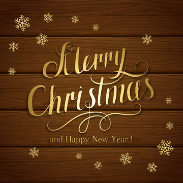 Merry Christmas with snowflakes on brown wooden background