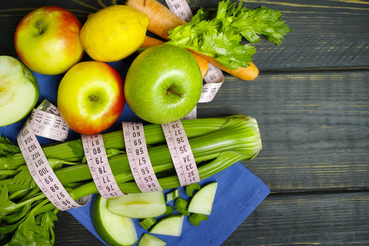 Green vegetables and fruits -  celery shoots and  apples, dietary fitness concept