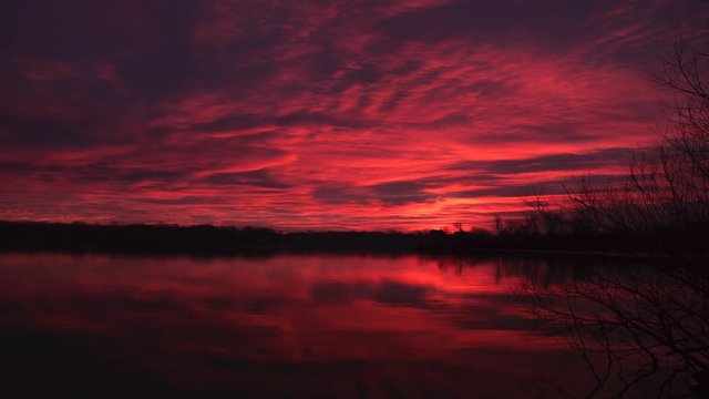 Red sky at morning, dawn over Fox River, De Pere, Wisconsin, time lapse.
