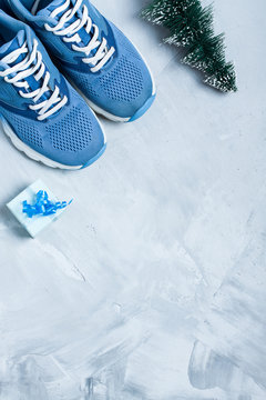 Christmas sport composition with shoes, and blue gift box