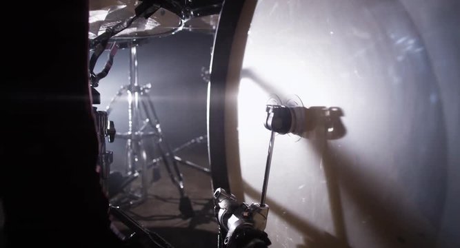 Closeup of drummer's foot moving drum bass pedal. Drummer Drumming on Stage