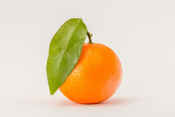 Ripe mandarin orange citrus with green leaf isolated on white background