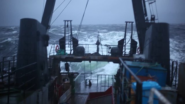 Aft part of the ship is swinging on the waves during a storm