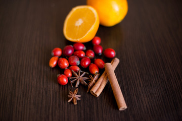 fruits, berries and spices on a brown table