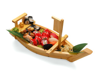 Japanese cuisine. Sushi set on a wooden plate isolated on white background