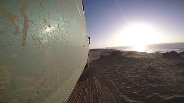 Small van driving in the sand - Morocco