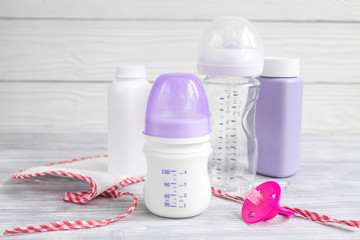 baby bottle with milk on wooden background