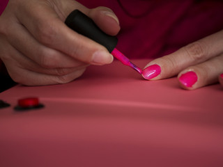 Female manicuring her own nails.