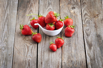 fresh juicy organic strawberries on an old wooden textured table