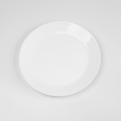 empty white plate on the white table