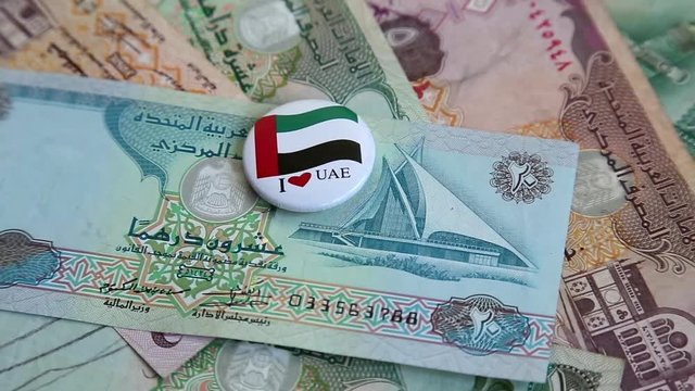 Arab money UAE dirhams on rotating surface background