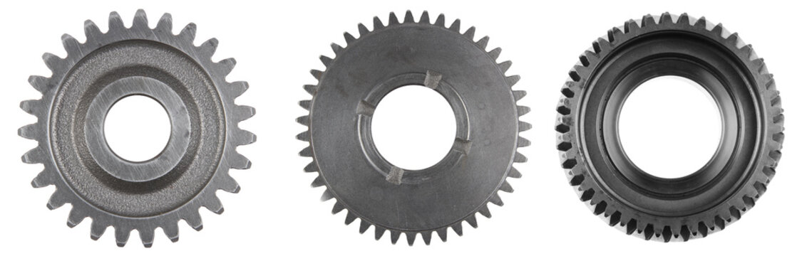 Three steel cog gears isolated over white