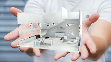 Businessman holding white 3D rendering apartment in his hand