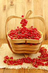 berries of red currant on the wooden vase